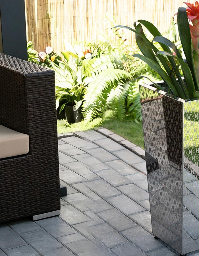 CYC Tapered Mirrored Textured Planter besides a sofa