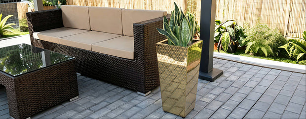 CYC Tapered mirrored Planter box besides a sofa and a table